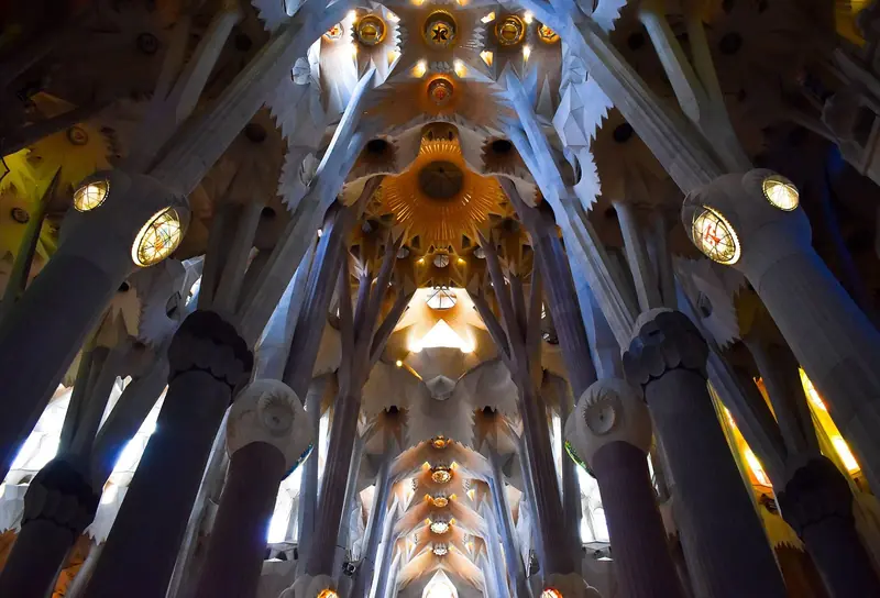 Teto da nave da Sagrada Família, com colunas ramificadas como árvores e a abóbada iluminada